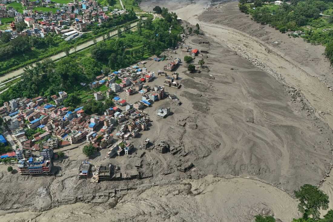 Des maisons endommagées se dressent de manière précaire près des berges gonflées et obstruées par les débris de la rivière Trishuli après des crues soudaines dans le district de Nuwakot au Népal, le mercredi 26 août 2026. (AP Photo/Niranjan Shrestha)