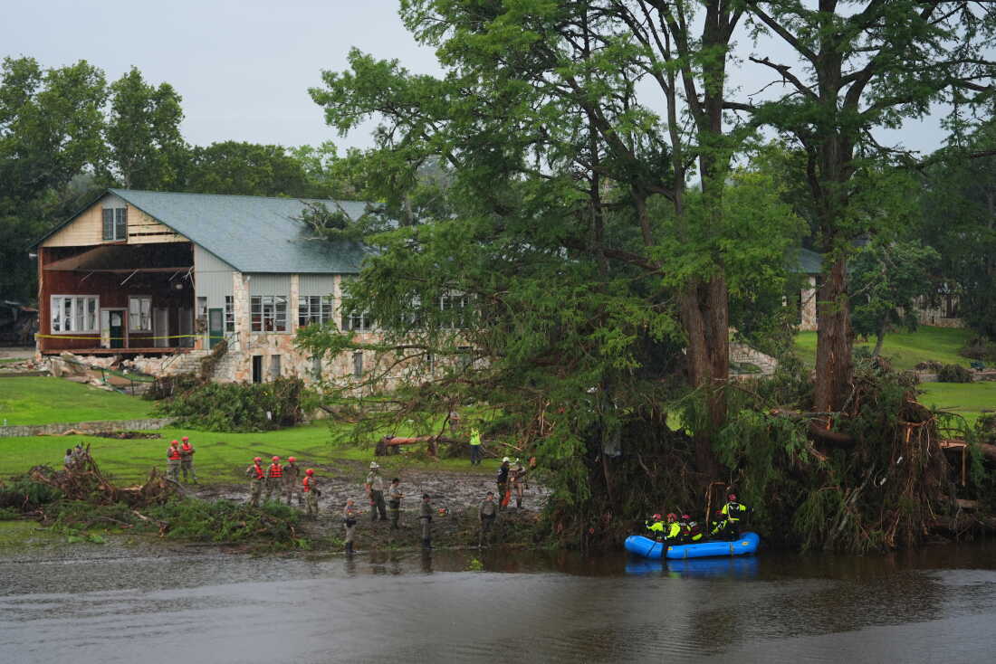 Des secouristes sont vus sur terre et sur un bateau alors qu'ils recherchent des personnes disparues près de Camp Mystic à Hunt, au Texas, le long de la rivière Guadalupe après qu'une crue éclair meurtrière a balayé la région en juillet 2025.